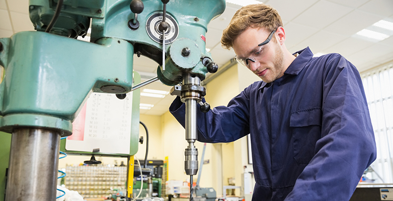 Engineering student using large drill