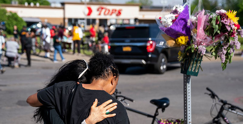 A photo of people gathered outside scene of Mass Shooting At Buffalo Food Market