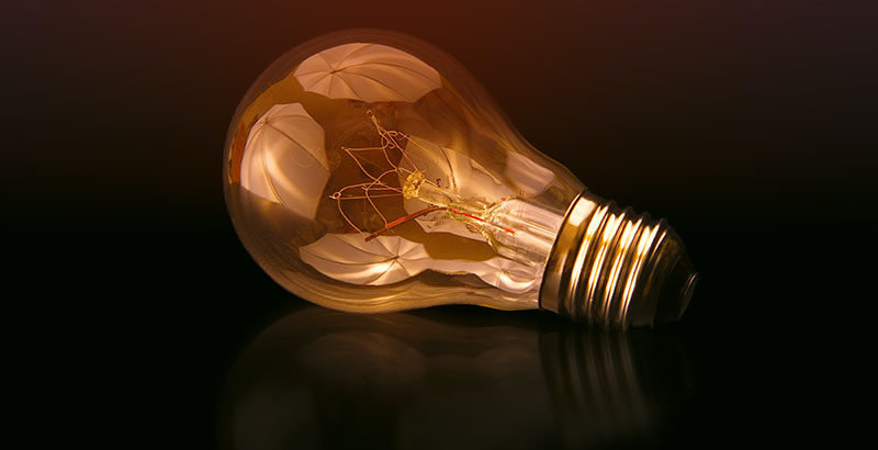 glowing lightbulb on dark background