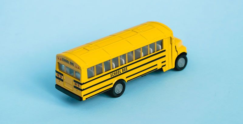 Graphic of play school bus on blue background