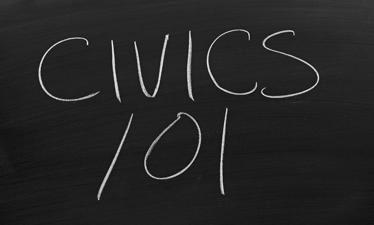 The words "Civics 101" on a blackboard in chalk