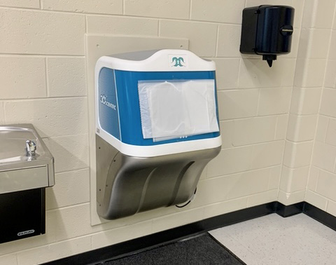 A photo of a hand-rinsing machine in a school bathroom