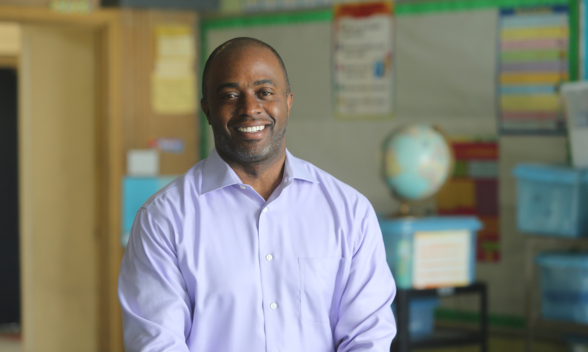 A portrait of Tony Thurmond in a classroom