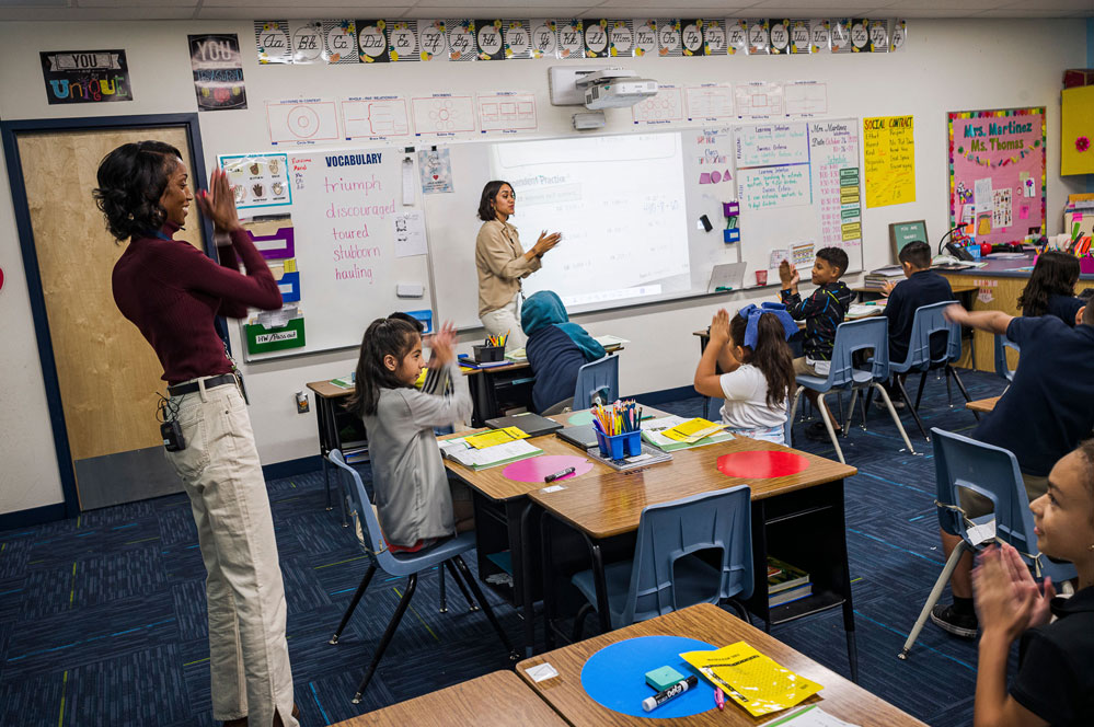 A news photo of an elementary classroom in Arizona. There are a handful of empty desks.