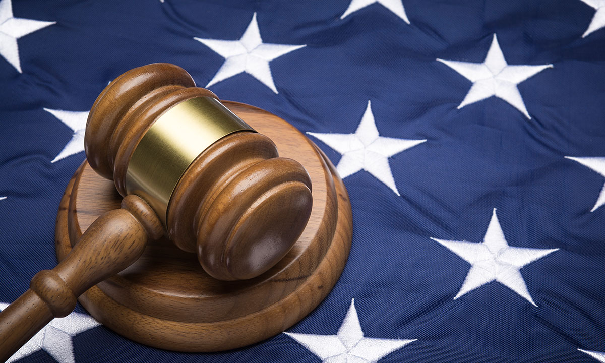 A photo of a gavel on the blue part of an American flag