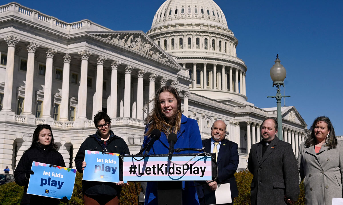 Rebekah Bruesehoff speaks at a podium outside the U.S. Capitol building; the sign on the podium says hashtag Let kids play.