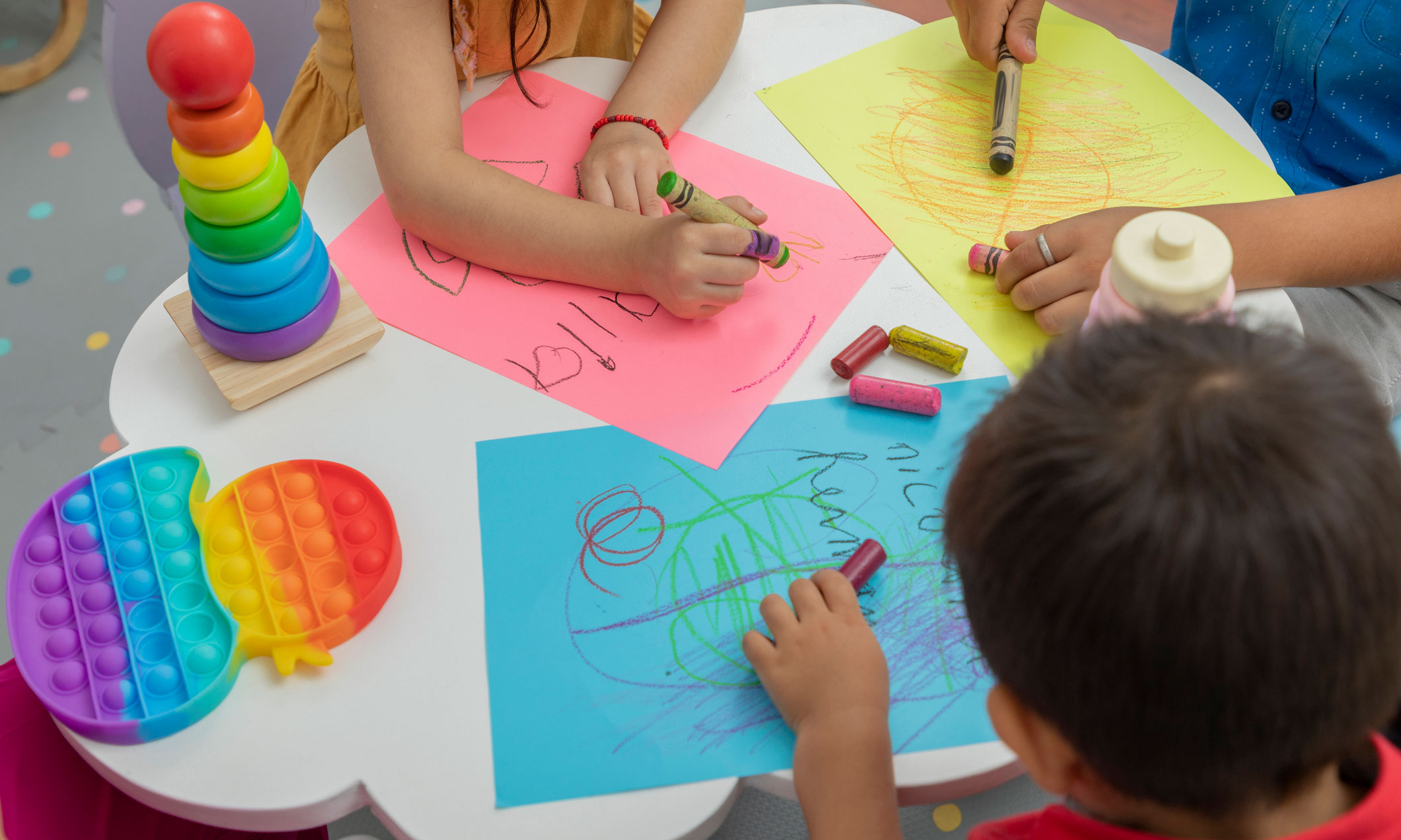 This photo shows children coloring at school.