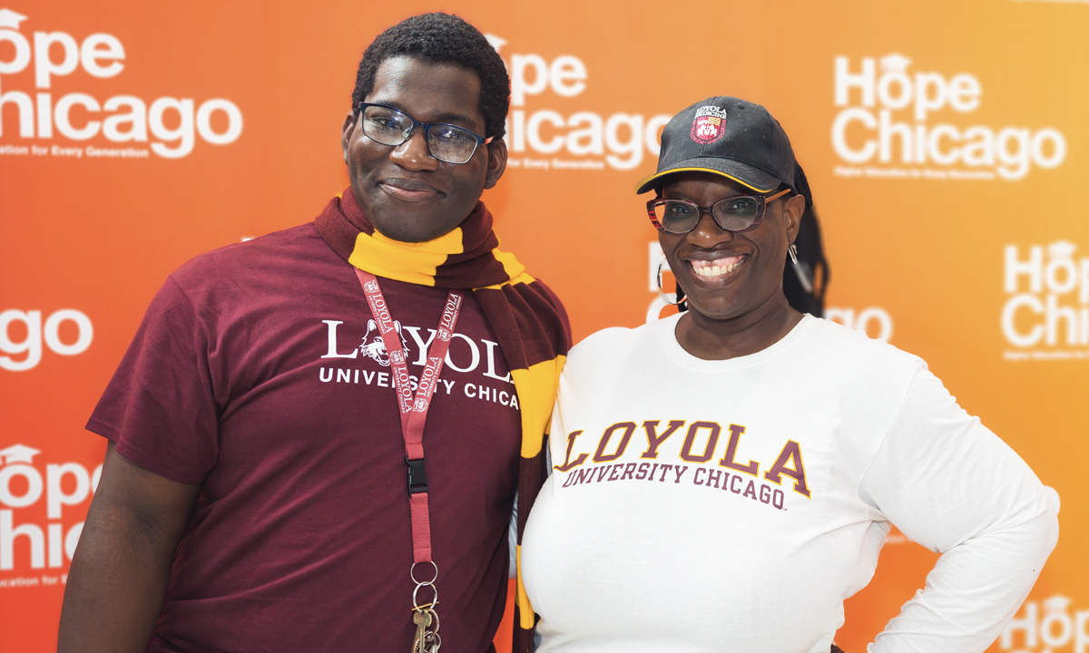 This is a photo of Ajani Cunningham and his mother wearing Loyola University shirts.