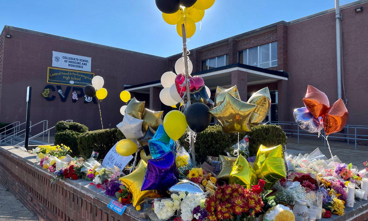 This is a photo of flowers and balloons at a memorial for school shooting victims.