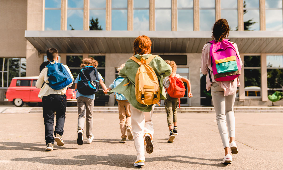 This photo shows students running into a school building.