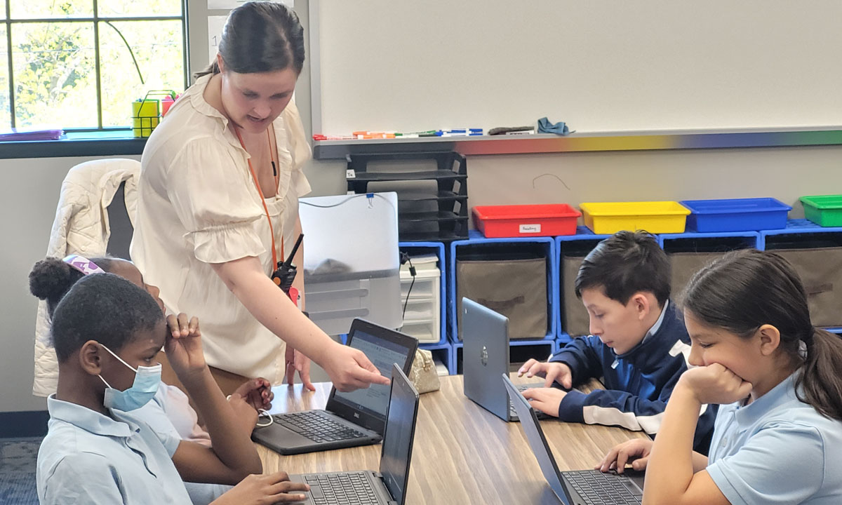 This is a photo of a teacher at Paramount Cottage home teaching students.