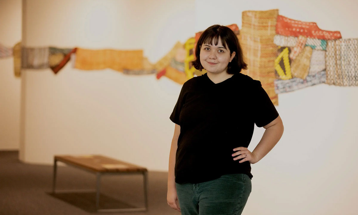 This is a photo of University of Texas - Austin sophomore Katelan Crowder posing at the Ellen Noël Art Museum's temporary exhibit hall in the Presidential Museum and Leadership Library in Odessa.