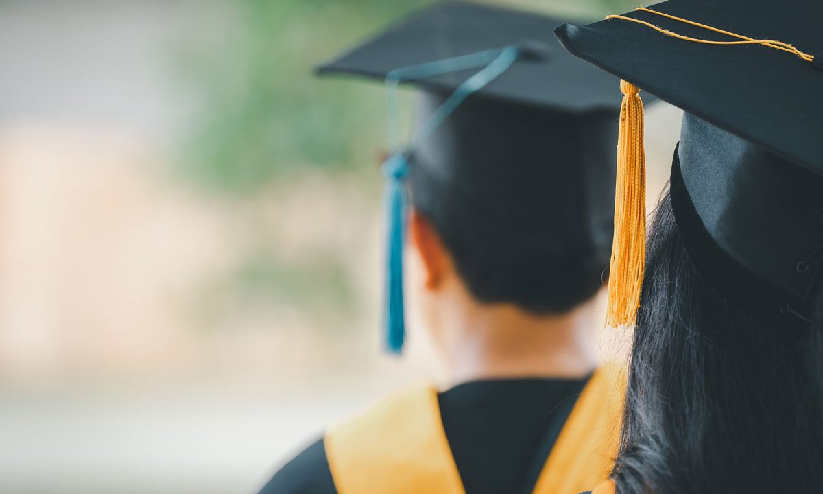 This is a photo of two students in cap and gowns.