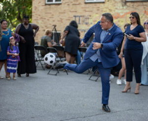 This is a photo of U.S. Secretary of Education Miguel Cardona playing soccer.
