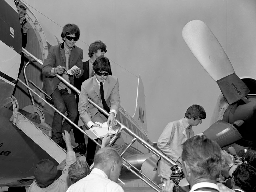 A photo of the beatles signing autographs