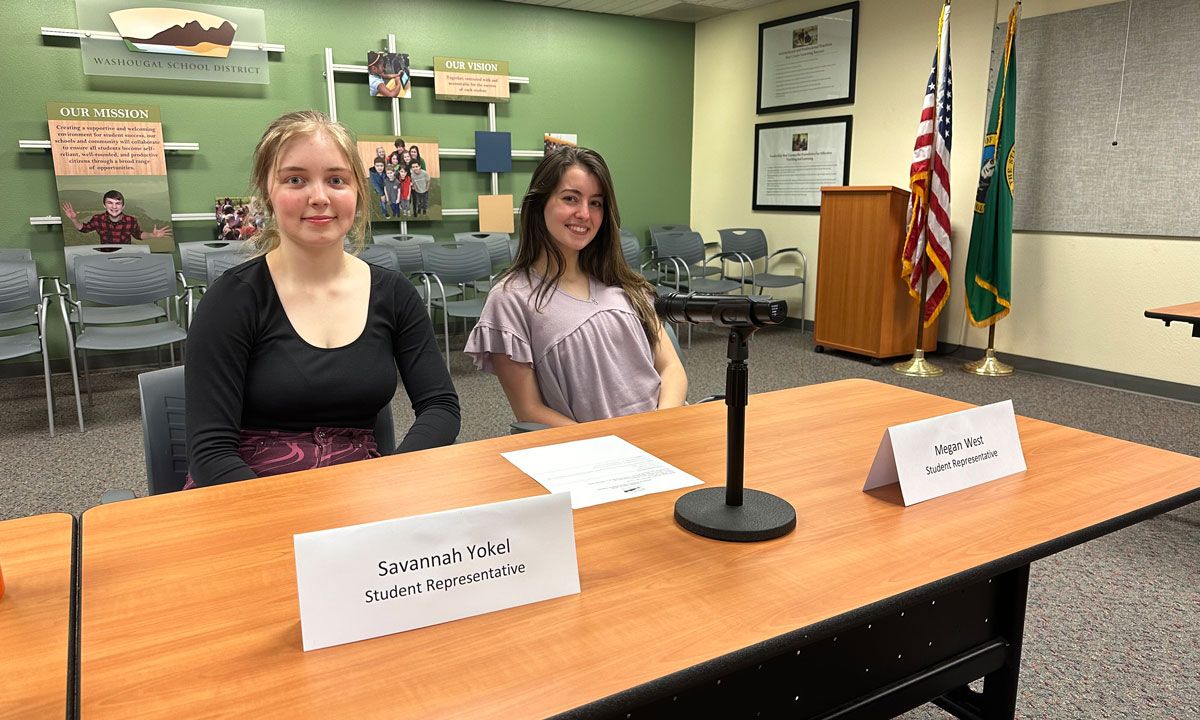 This is a photo of two student representatives at a school board meeting in Washington state.