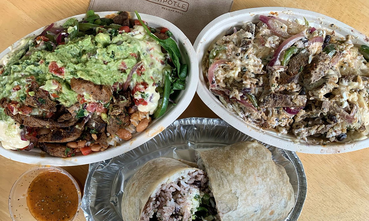 This is a photo of two burrito bowls and a burrito from fast food chain Chipotle.