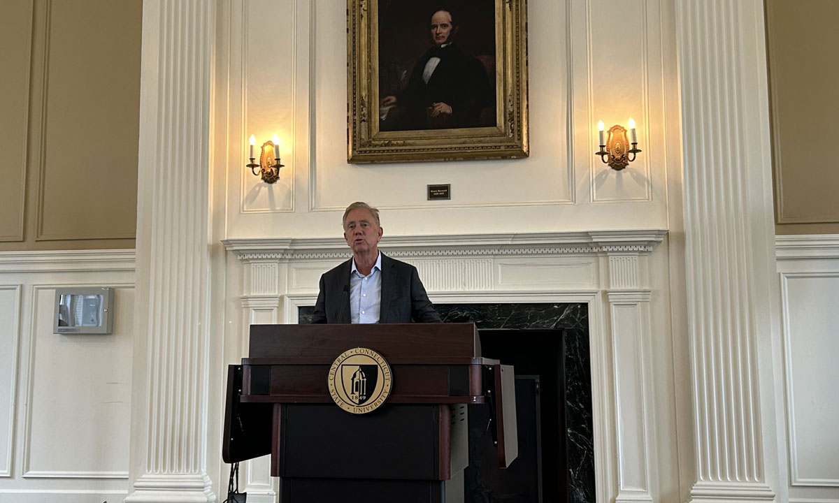 This is a photo of Connecticut Governor Ned Lamont speaking at a podium.