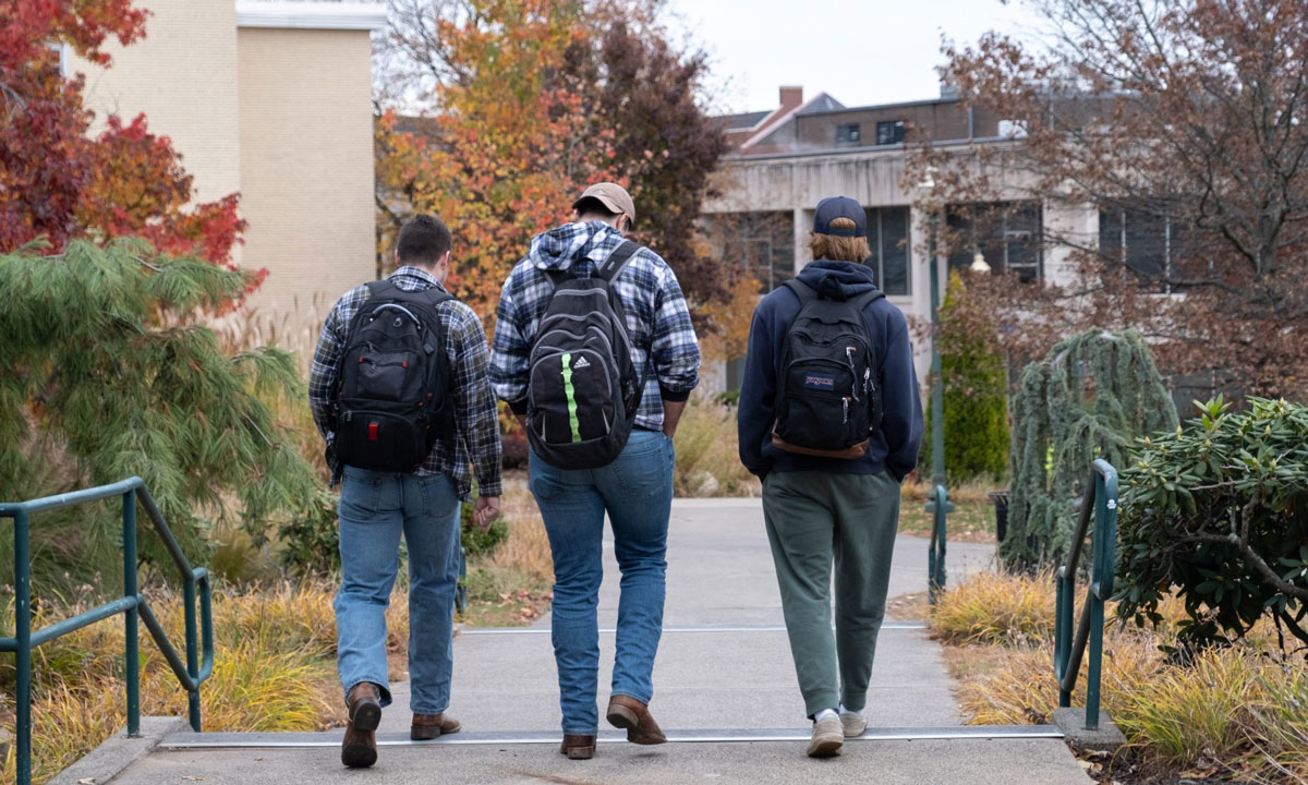 This is a photo of three students walking on a college campus.