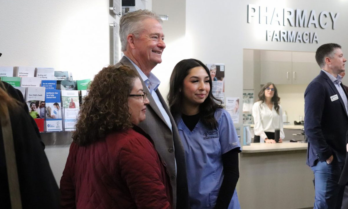 This is a photo of Idaho Governor Brad Little posing with a student and parent.