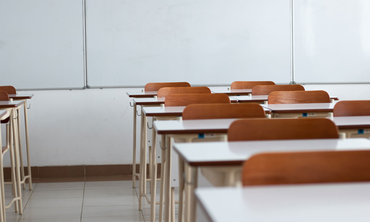 This is a photo of desks in an empty classroom.