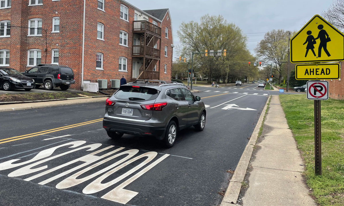 This is a photo of a car driving through a school zone.