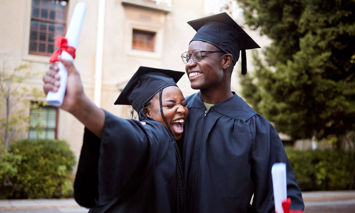 A photo of two Black students graduating