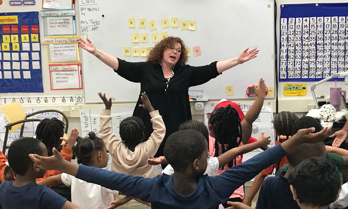 This is a photo of a teacher teaching phonics to her students.