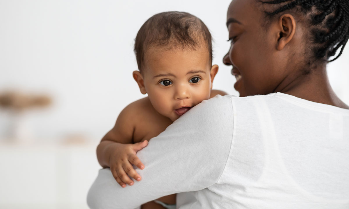 This is a photo of an African American mom holding her baby.