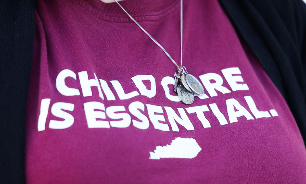 This is a photo of a shirt that says "child care is essential."