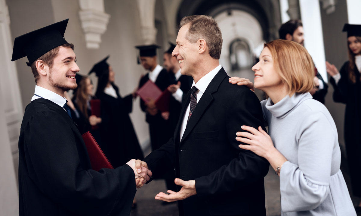 This is a photo of parents standing with their graduating son.