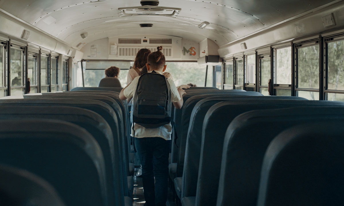 This is a photo of students getting off of a school bus.