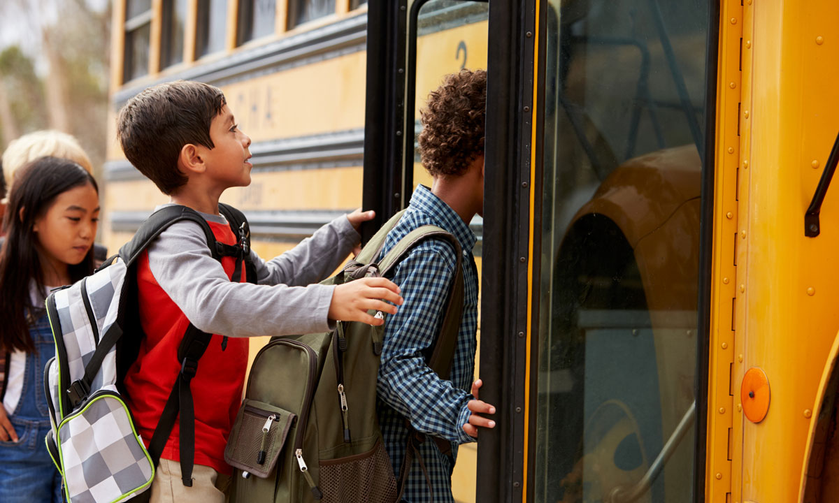 This is a photo of students getting on a school bus.