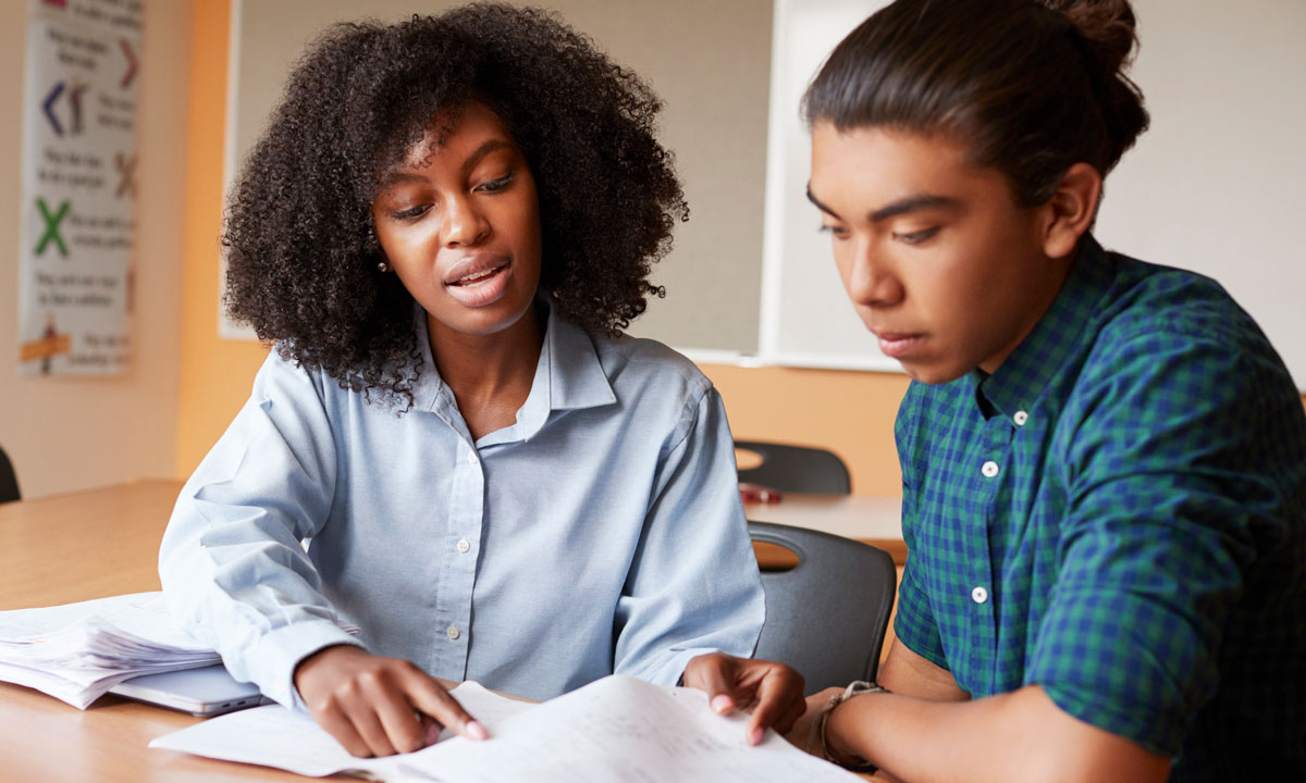 This is a photo of a teacher tutoring a student.