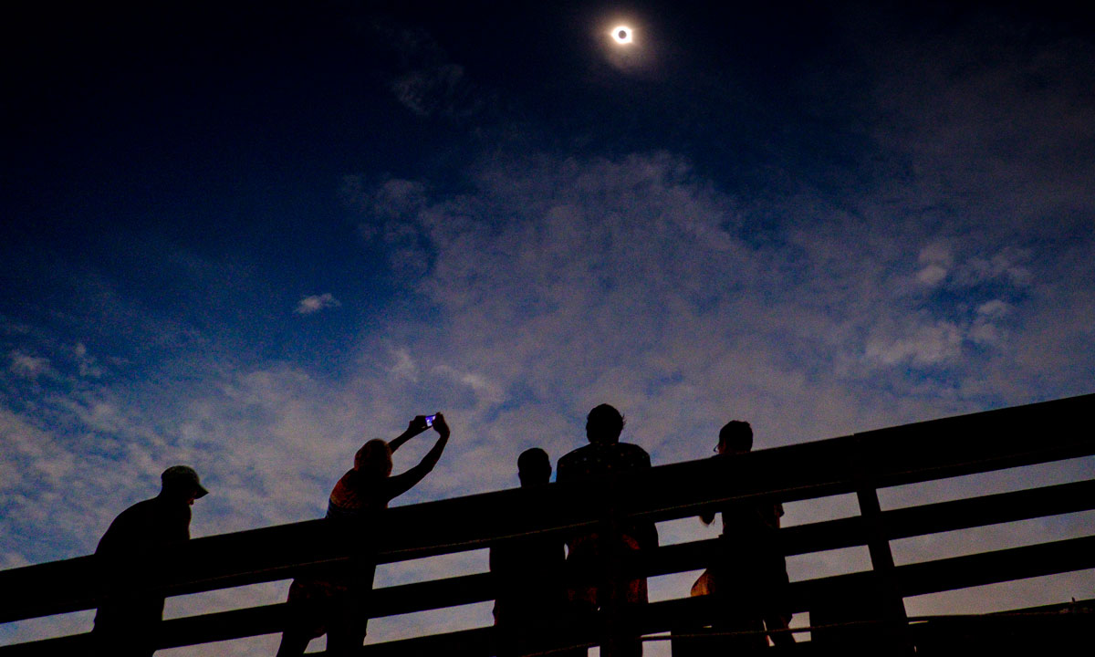 This is a photo of a group of people looking at a solar eclipse.