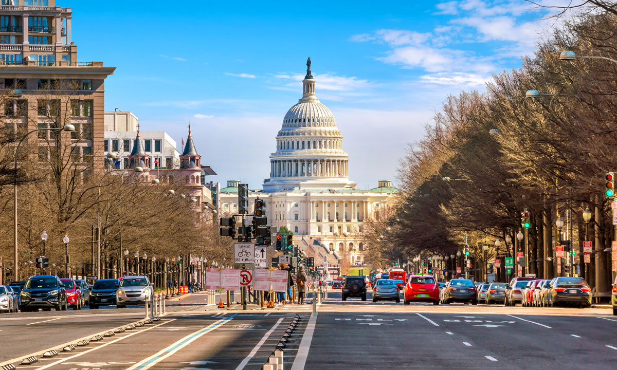 This is a street photo of Washington D.C. with the U.S. Capitol building in the distance.
