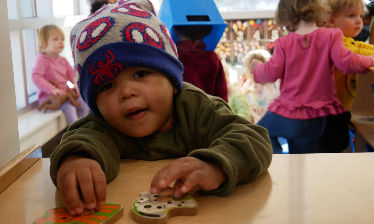 This is a photo of a young boy sitting at a table.